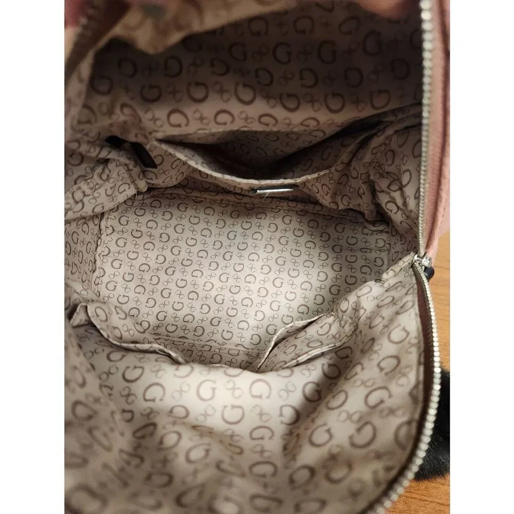 Guess small velvet feel pink backpack with black straps and pom. Measures approx